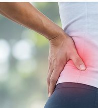A person holding their hip, with the painful area highlighted
